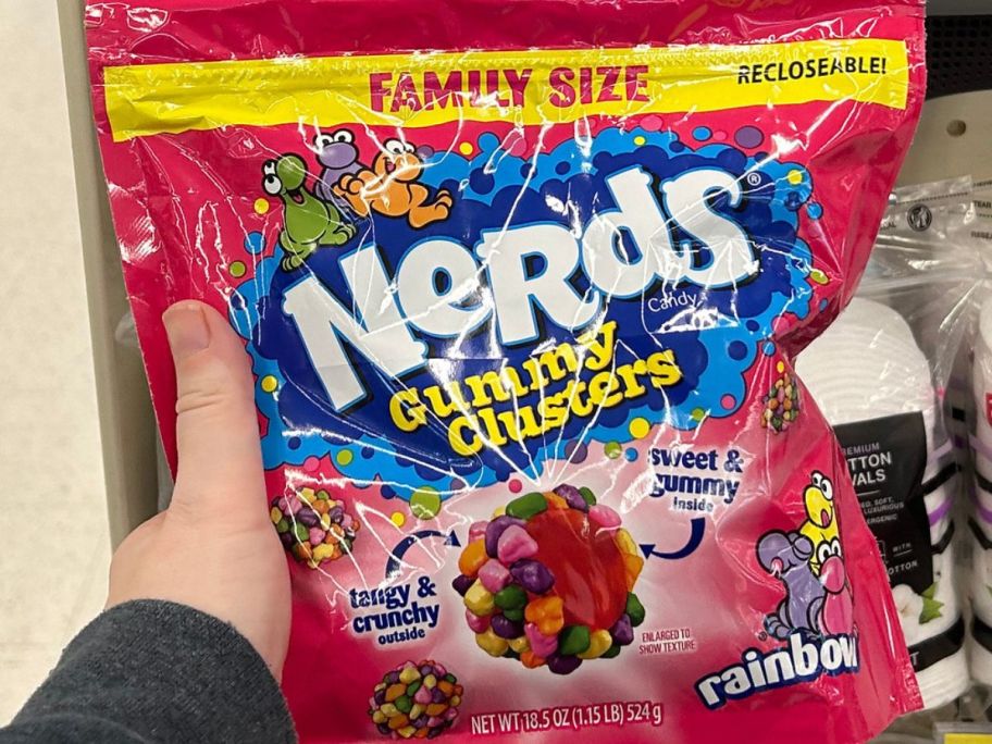 Hand holding a family size bag of Nerds Gummy Clusters