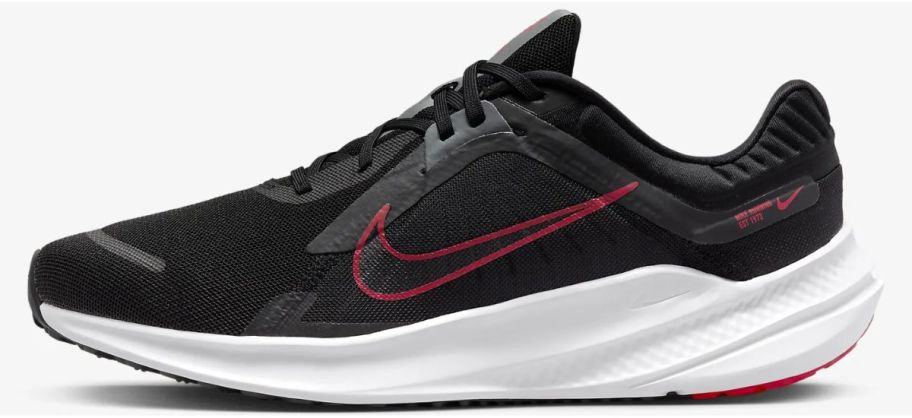 a mens black nike running shoe with white sole and black swoosh with red outline