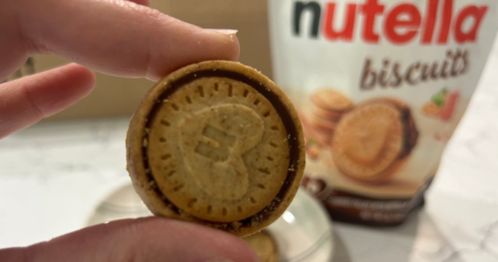 person holding nutella biscuit