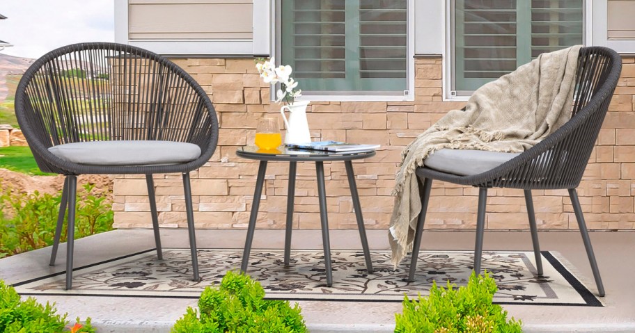 woven patio chairs and table set on front porch