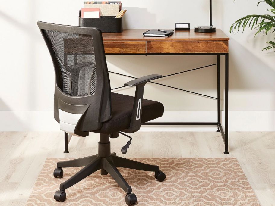 A Realspace Radley Mesh Mid-Back Task Chair in front of a desk