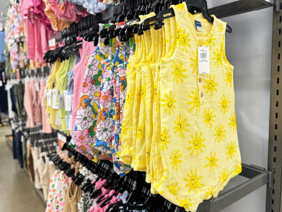 store display rack full of baby rompers on hangers