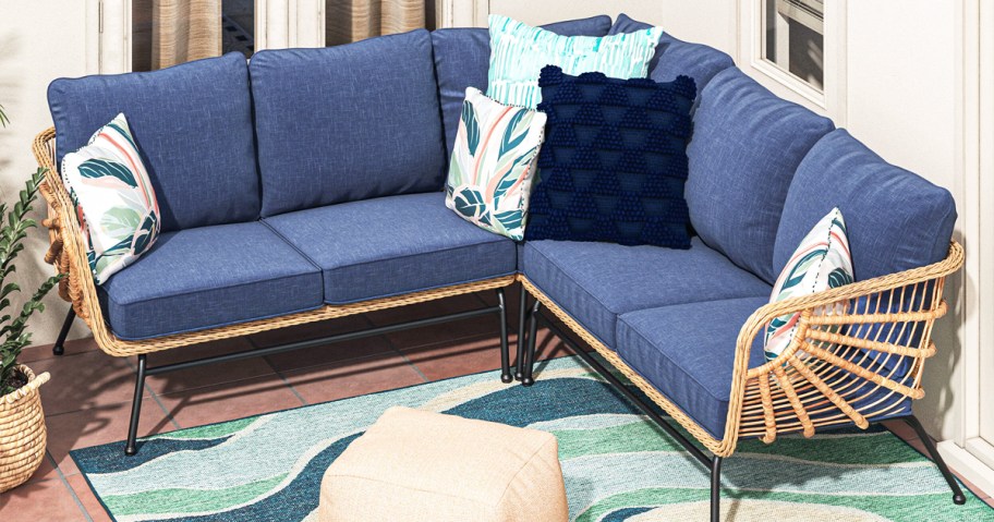 wicker patio couch with dark blue cushions