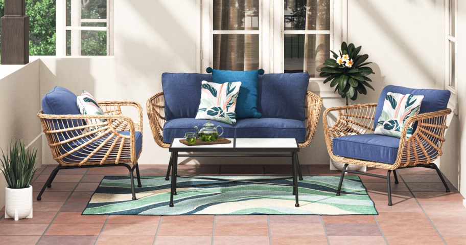 wicker patio set with two chairs, loveseat, and coffee table