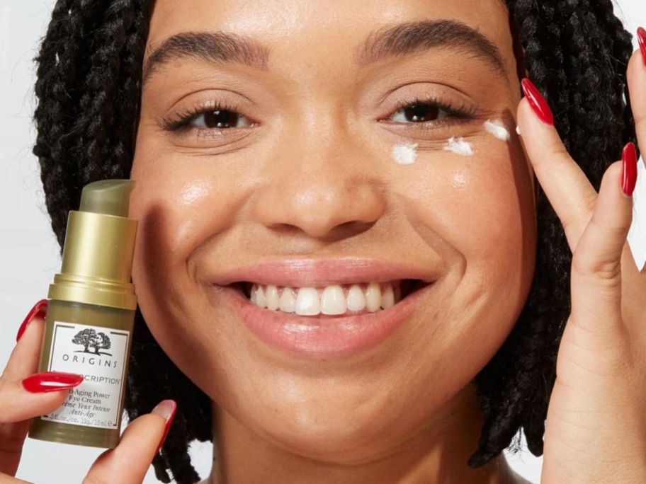 woman applying Origins Plantscription Eye Cream under her eye