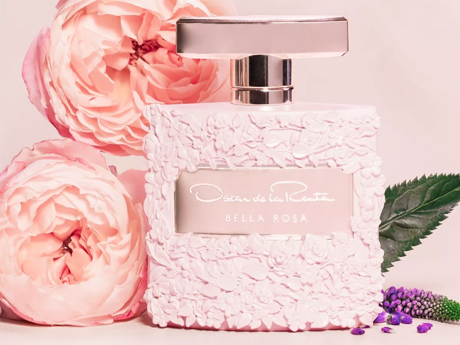 pink bottle of Oscar De La Renta Bella Rosa Eau de Parfum with pink peony flowers