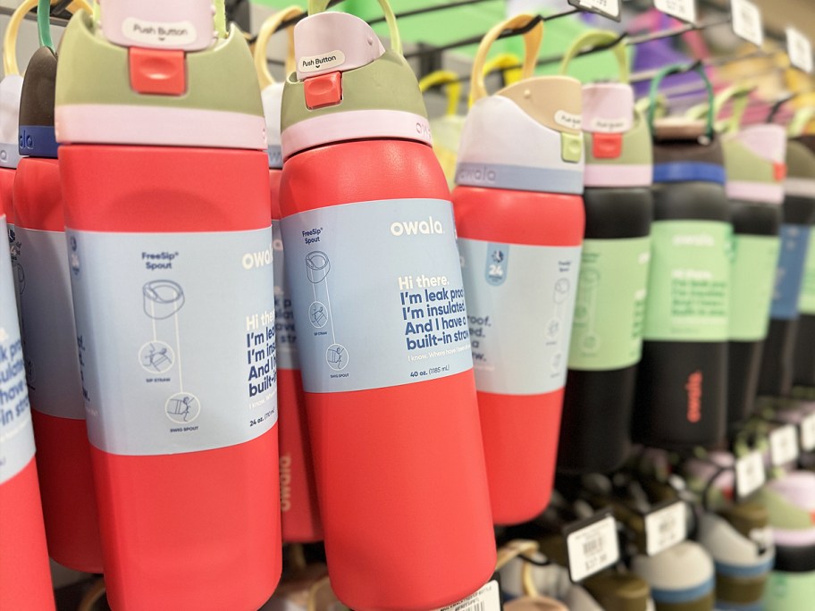 red owala water bottles hanging on store display