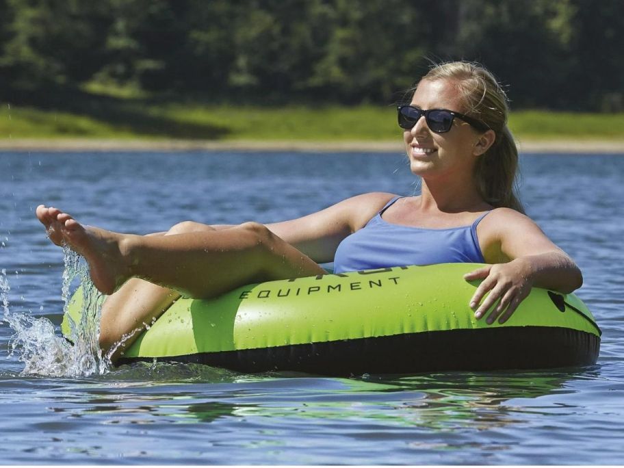 A woman floating on a tube in a lake