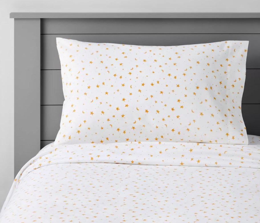 stock photo of white star sheets on gray wood bed