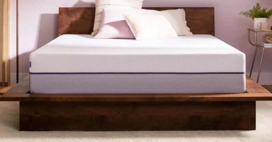 mattress on a wood bed frame