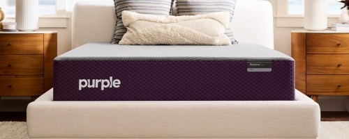 purple mattress on an upholstered bed frame