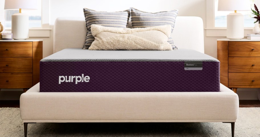 purple mattress on an upholstered bed frame