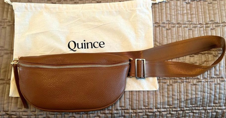 A Quince Italian Pebbled Leather Sling Bag in Cognac with bag