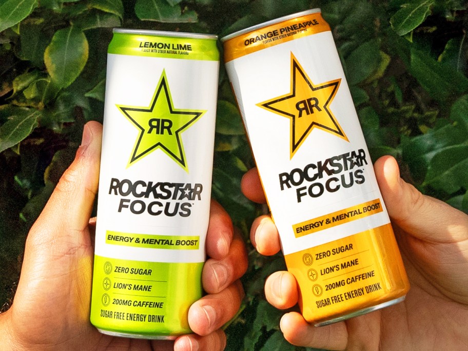 two hands holding up cans of Rockstar Focus Energy Drinks