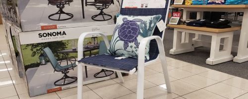 A sonoma patio chair with a throw pillow on it