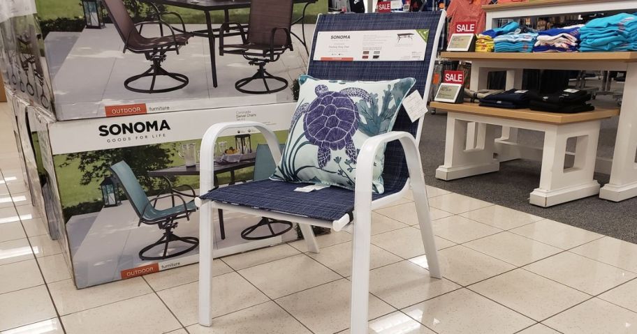 A sonoma patio chair with a throw pillow on it
