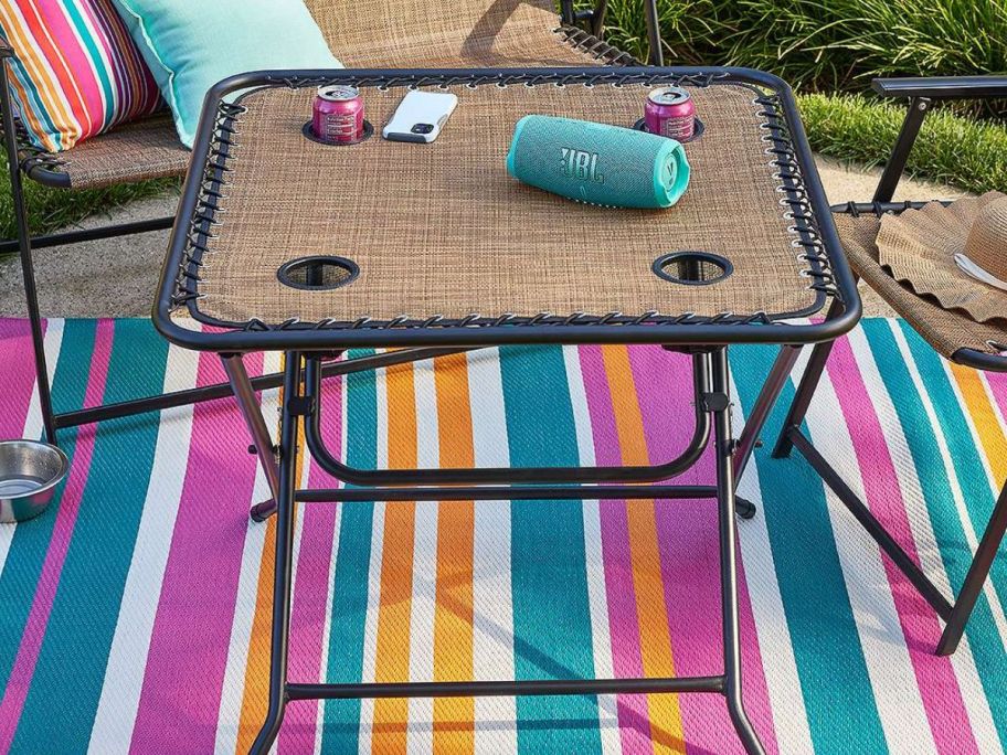 A sonoma antigravity folding table with a JBL speaker on it