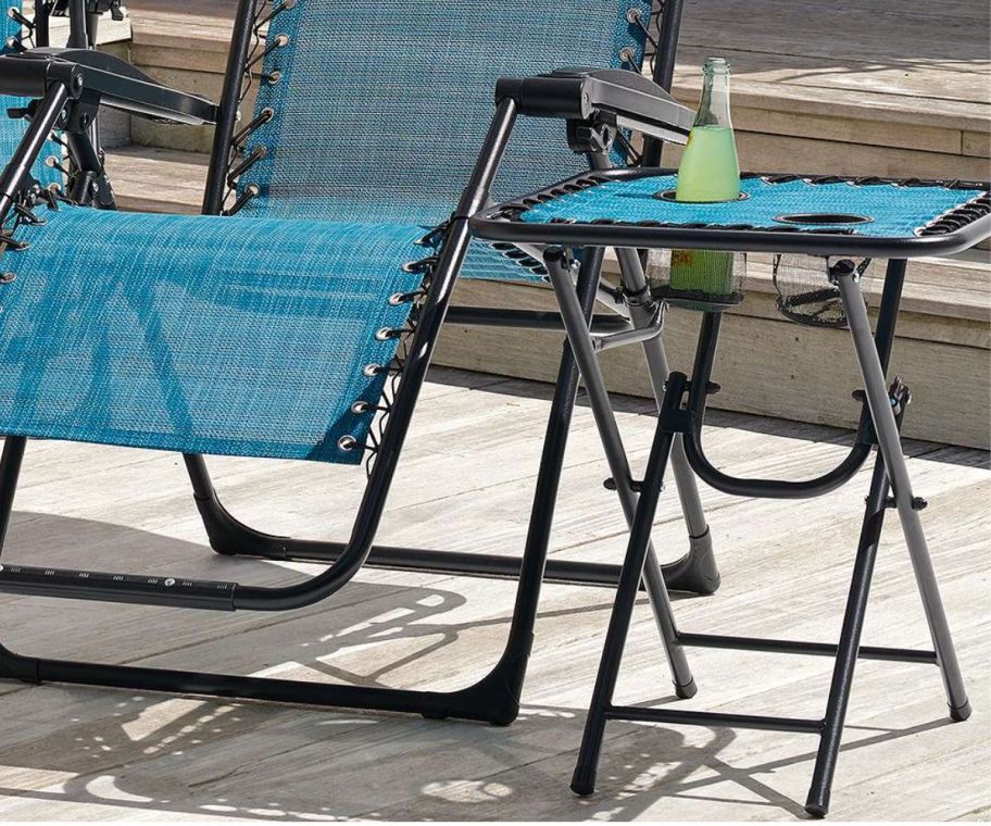a sonoma goods folding end table sitting next to a folding patio lounge chair