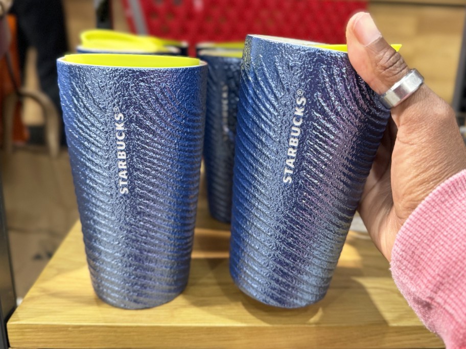 hand holding a blue starbucks cup with ridge texture