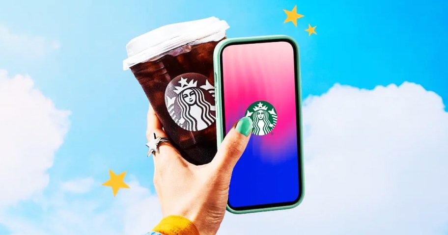 hand holding up a starbucks drink and iphone with starbucks app
