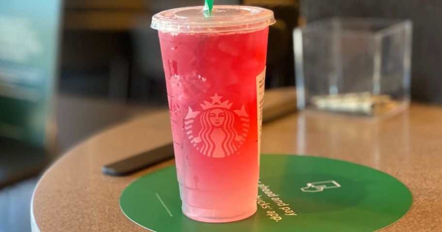 A large Starbucks drink on their counter