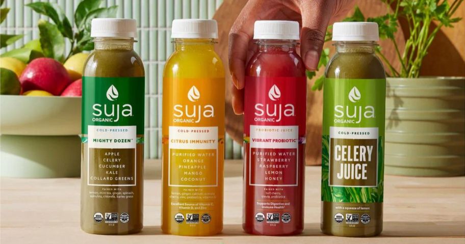 4 Suja Organic Juice bottles on a counter