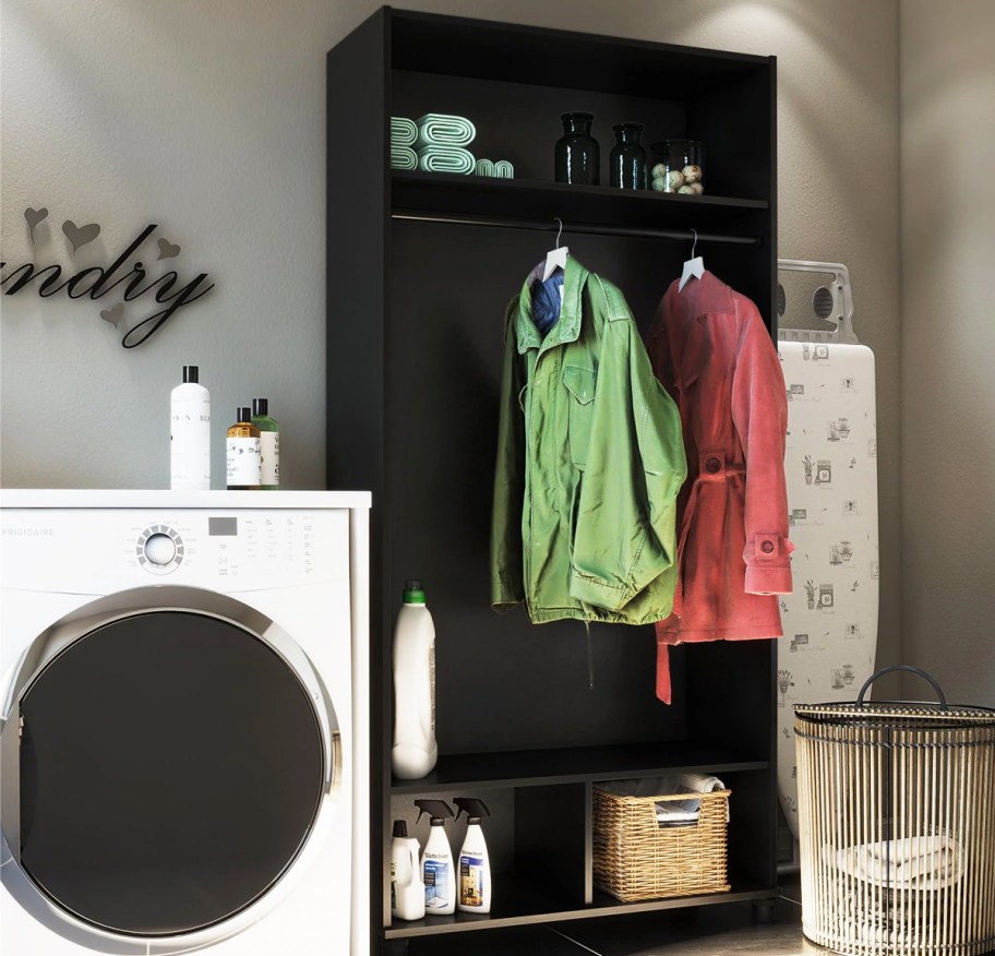 black mudroom cabinet with coats hanging inside