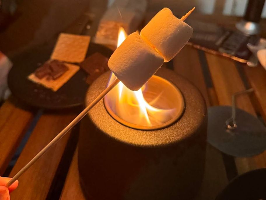 Marshmallows being roasted over a tabletop fireplace