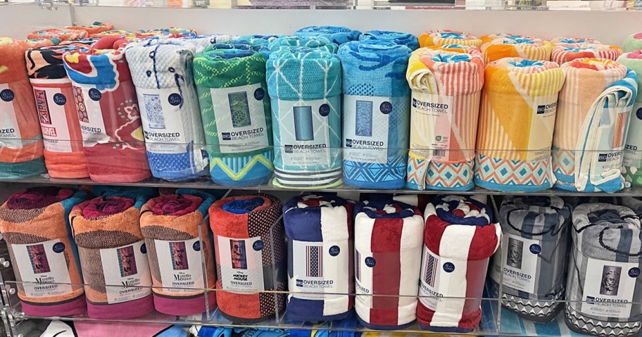 rolled up The Big One Oversized Beach Towels on store display