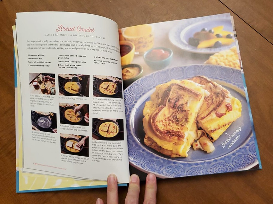 hand holding open page inside cookbook