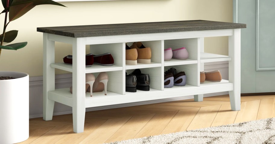 white bench with shoe storage cubbies underneath 