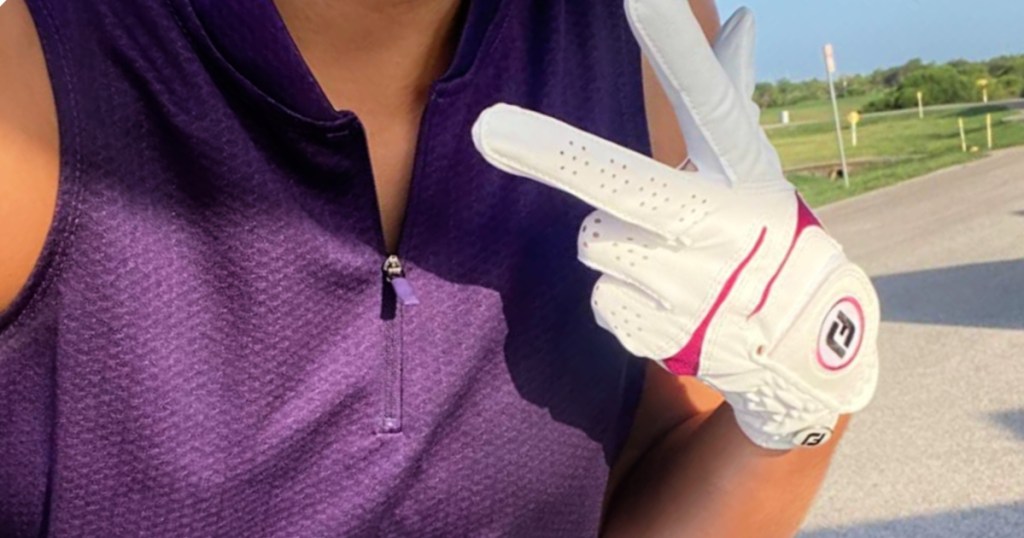 woman wearing purple sleeveless golf polo outside
