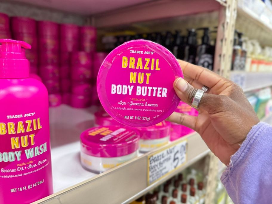 A hand holding a Trader Joe's Brazil Nut Body Butters