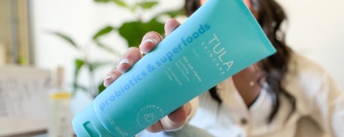 woman holding tula the cult classic purifying face cleanser