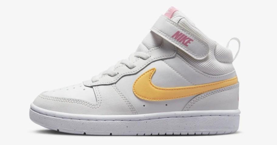 white, yellow and pink kid's Nike mid top shoe