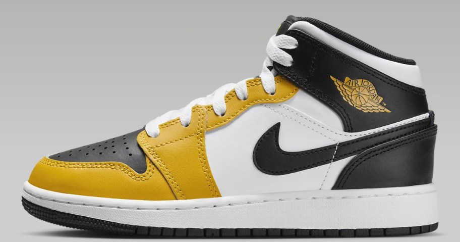 yellow, black and white kid's Nike Jordan mid shoe