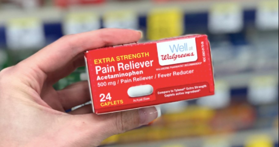 hand holding red box of pain relievers