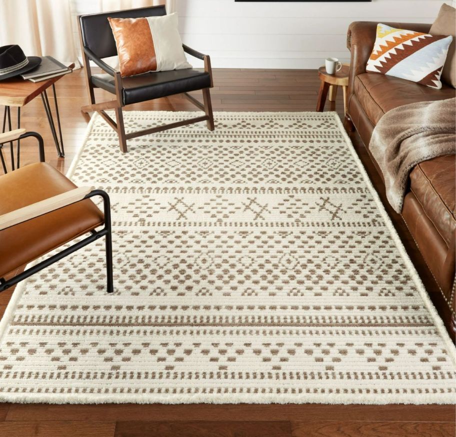 an ivory and brown washable area rug on a hardwood floor in a living room