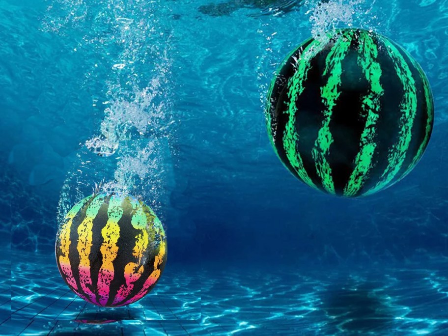 two watermelon pool toys sinking to bottom of pool