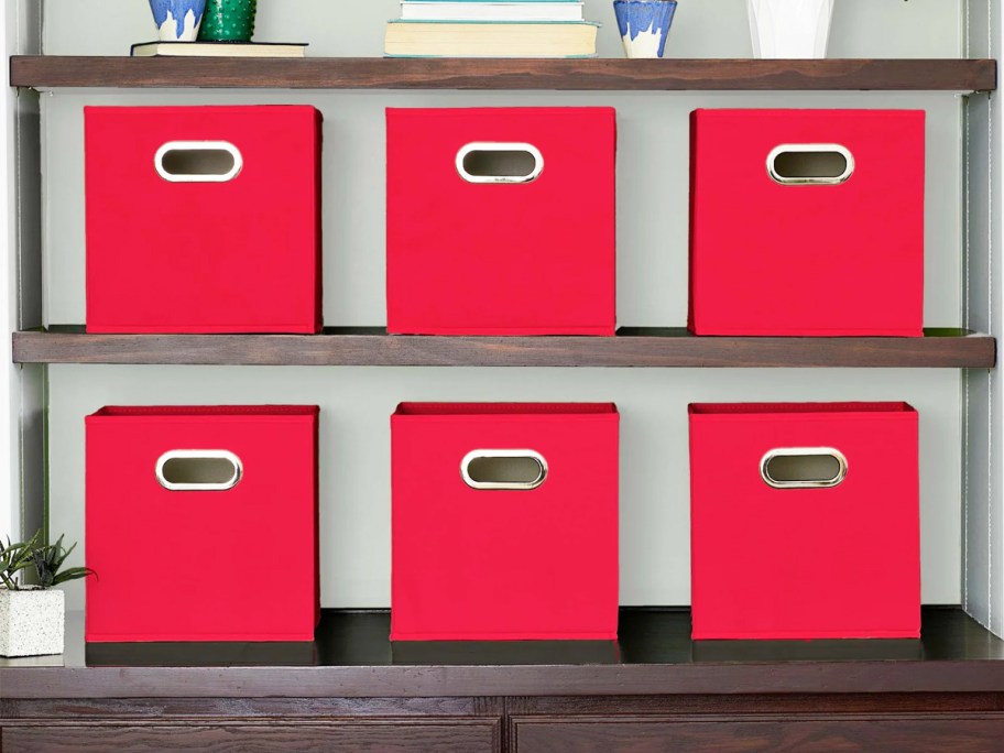 set of red fabric storage bins on bookcase