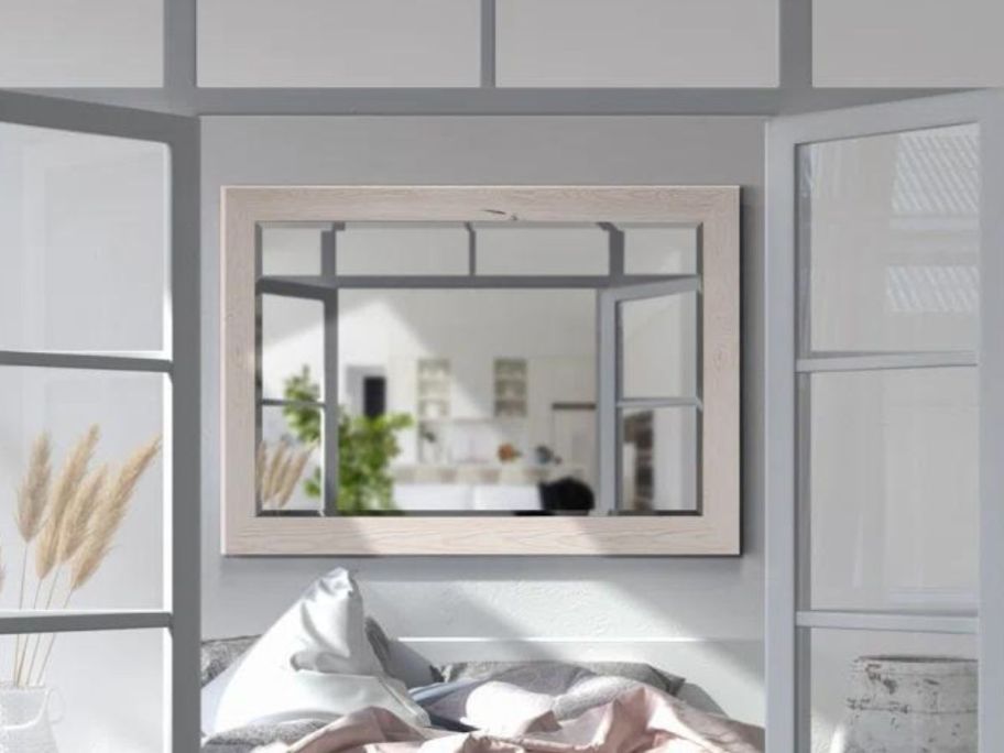 Trent Austin Design Migel Wood Flat Mirror on a wall above a bed