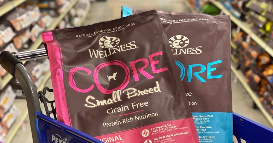 two bags of Wellness Core Dry Dog Food in blue shopping cart