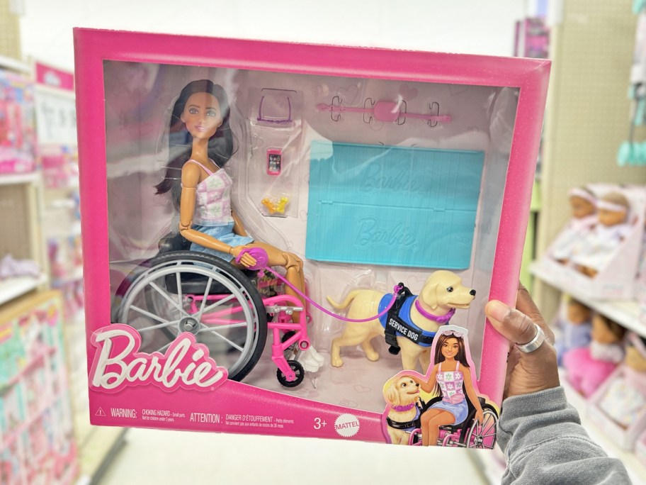 hand holding up a wheelchair barbie set in stores