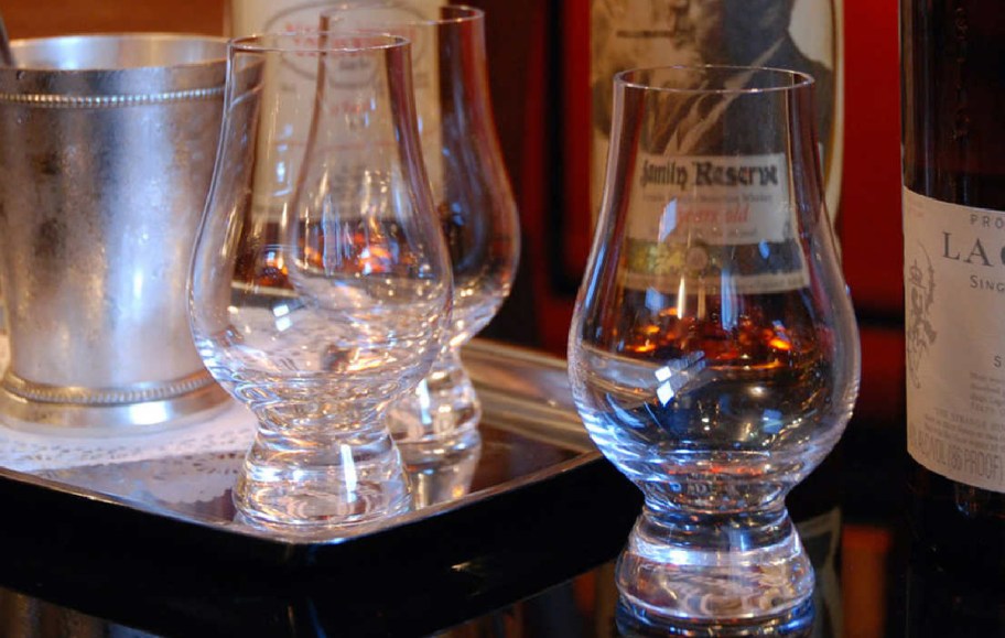 Whiskey glasses displayed on an at home bar