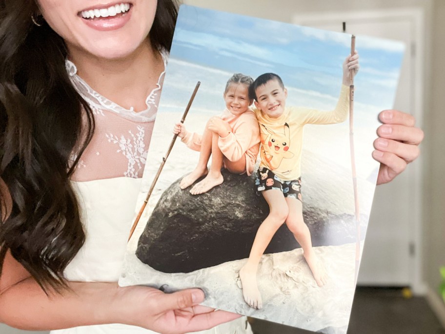 Woman holding metal photo print