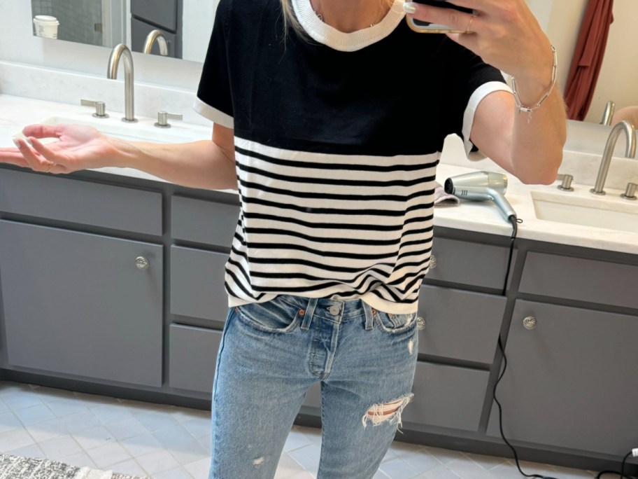 Woman wearing black and white stripped shirt with jeans