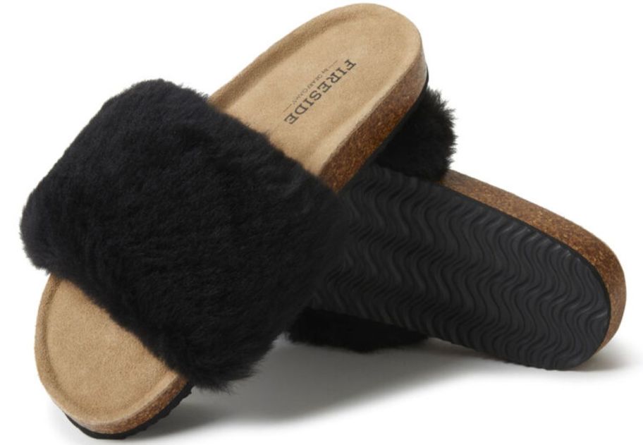 a pair of black shearling foot bed slides