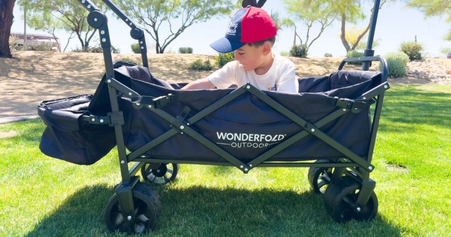 boy sitting in Wonderfold Push & Pull Wagon 