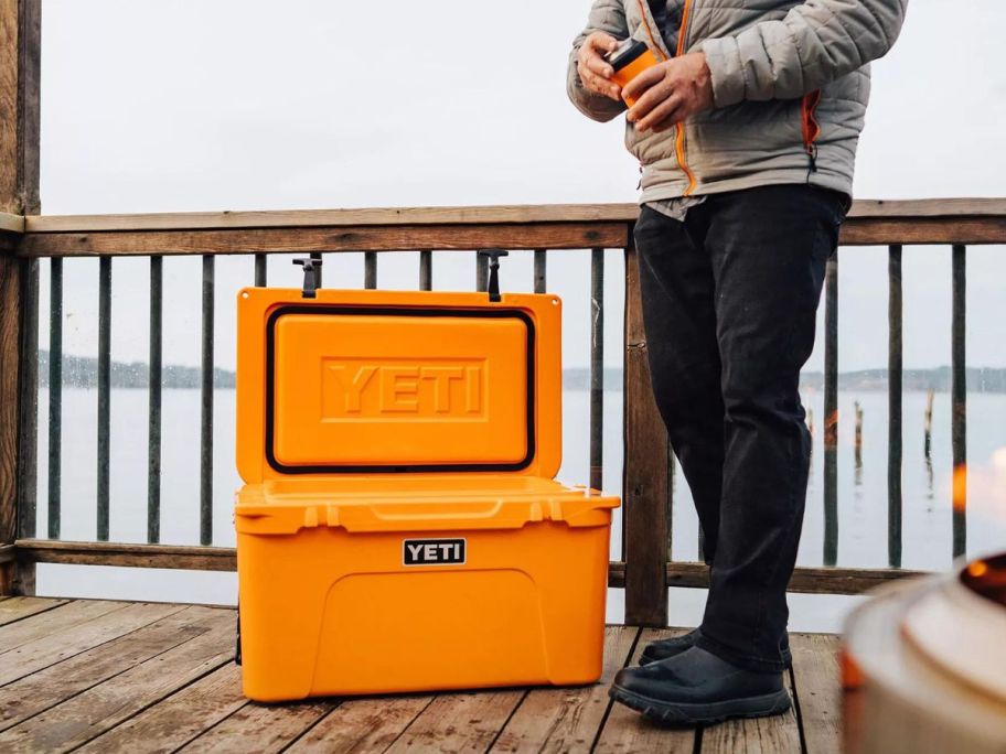 Man getting a drink from a YETI Tundra Cooler