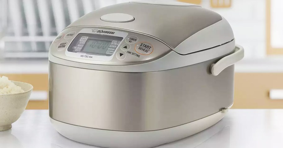 silver and white rice cooker on kitchen counter